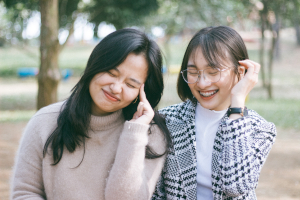 Two women smiling in a park